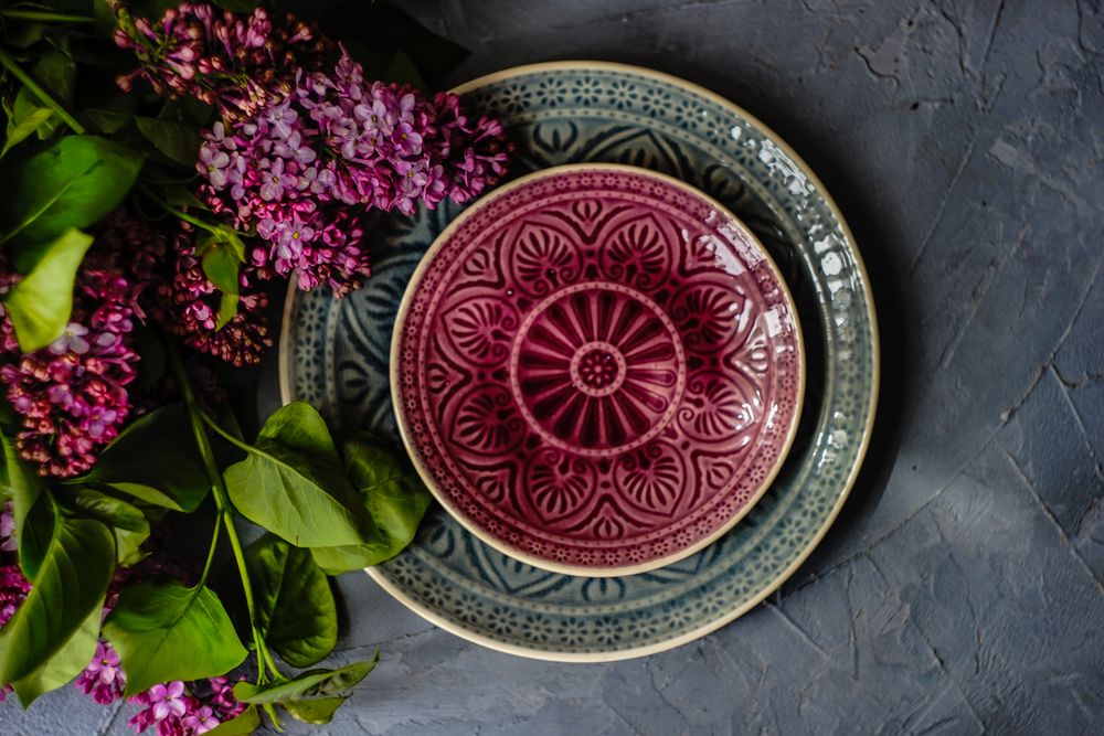 Spring floral card concept with patterned plates and lilac flowers