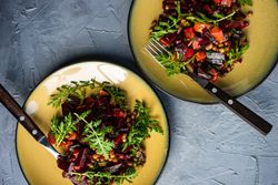 Top view of two beet salads served on yellow plates