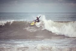 Man surfer on surfboard catching wave on ocean