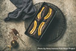 Freshly baked dark chocolate banana bread cake on concrete counter 4NYQ95