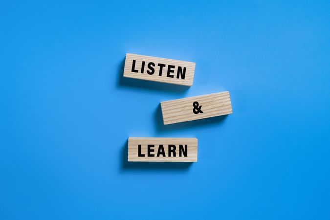 listen and learn words on turn wooden blocks isolated on blue background