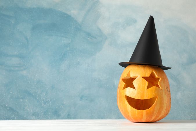 Funny pumpkin on wooden background, space for text