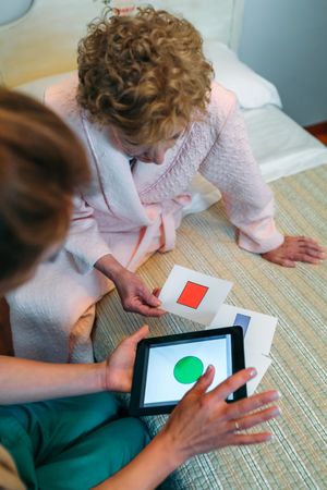 Female doctor showing geometric shapes to patient