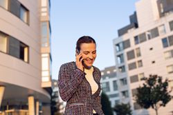 Smiling businesswoman answering phone call