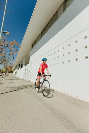 Sportswoman riding bicycle on street