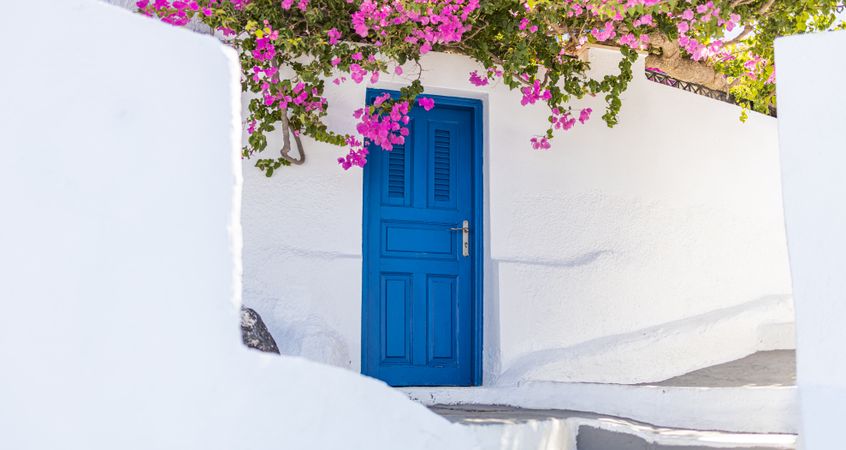 Blue door along a pathway in Santorini