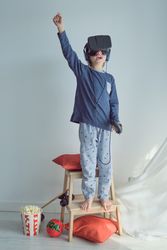 Boy playing VR game with gamepad