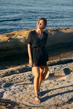 Calm woman enjoying sun on beach