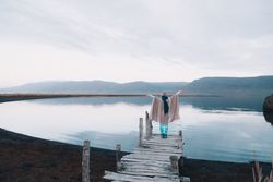 Woman on pier near wonderful lake