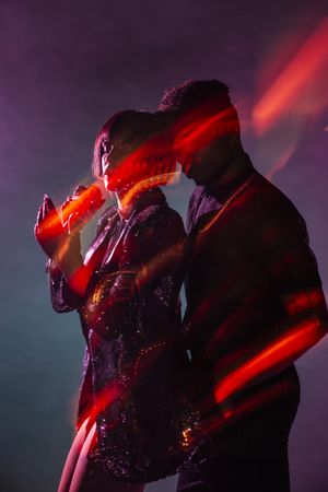 Sensual young dancers near smoke