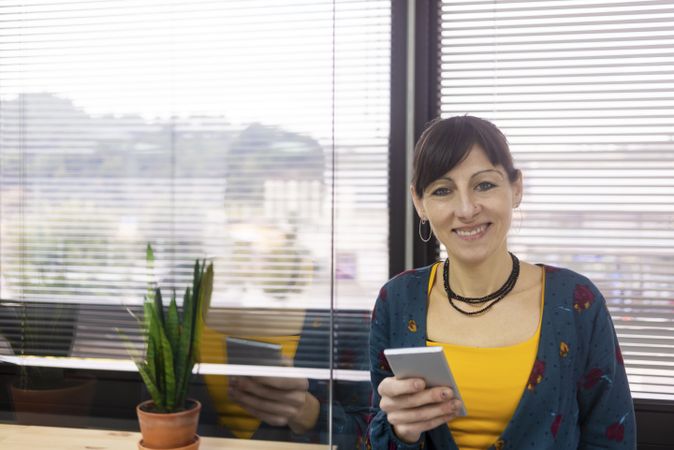 Businesswoman using smartphone at office