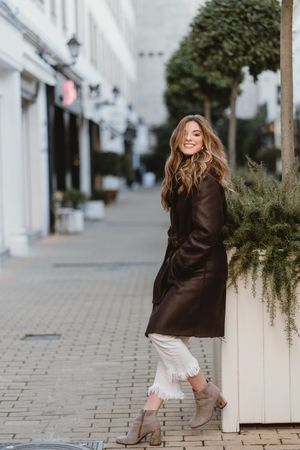 female standing on city street