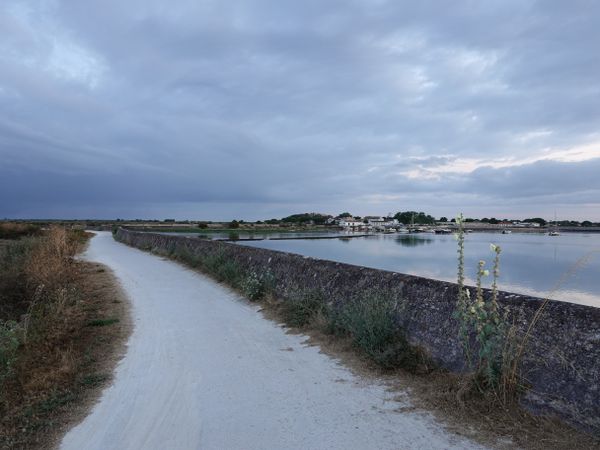 Bike path along dike to the Port of Loix, France.