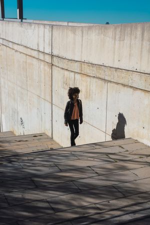 Black woman walking down the street.