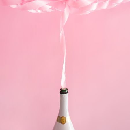 Champagne bottle with pink party ribbon