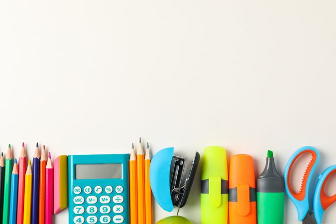 Frame of school supplies on blank background, space for text