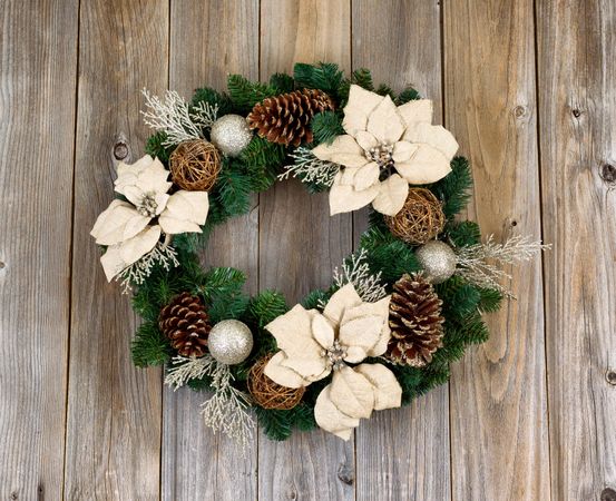 Holiday Poinsettia Christmas wreath on rustic cedar wood