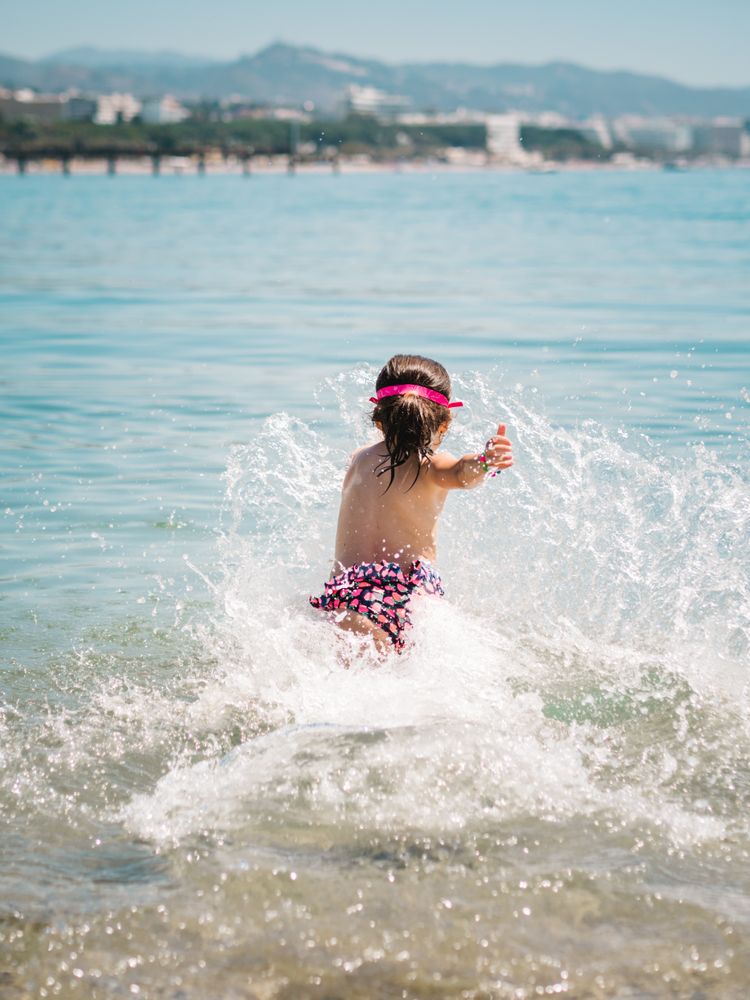 Cheerful girl having fun in warm sea