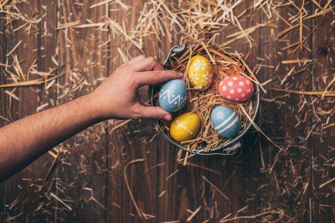 Hand placed Easter eggs on wooden stump