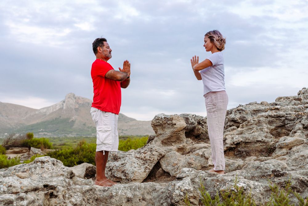 Couple meditating on rock