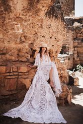 female sitting by ruined wall