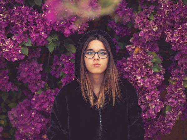 Woman on background of stunning violet flowers