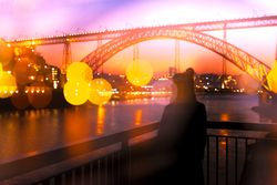 Anonymous woman standing on embankment in evening