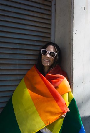 Woman posing happily with the LGBT flag