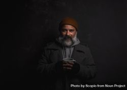Portrait of smiling middle aged man with gray hoodie with cup of hot tea 5avYW4