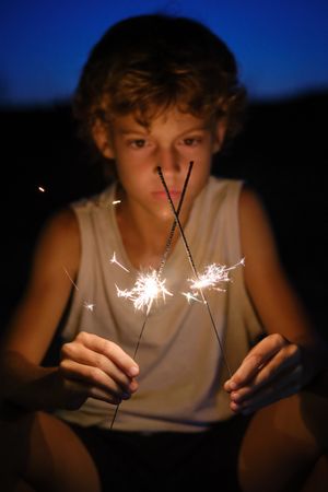 Boy with glowing Bengal lights