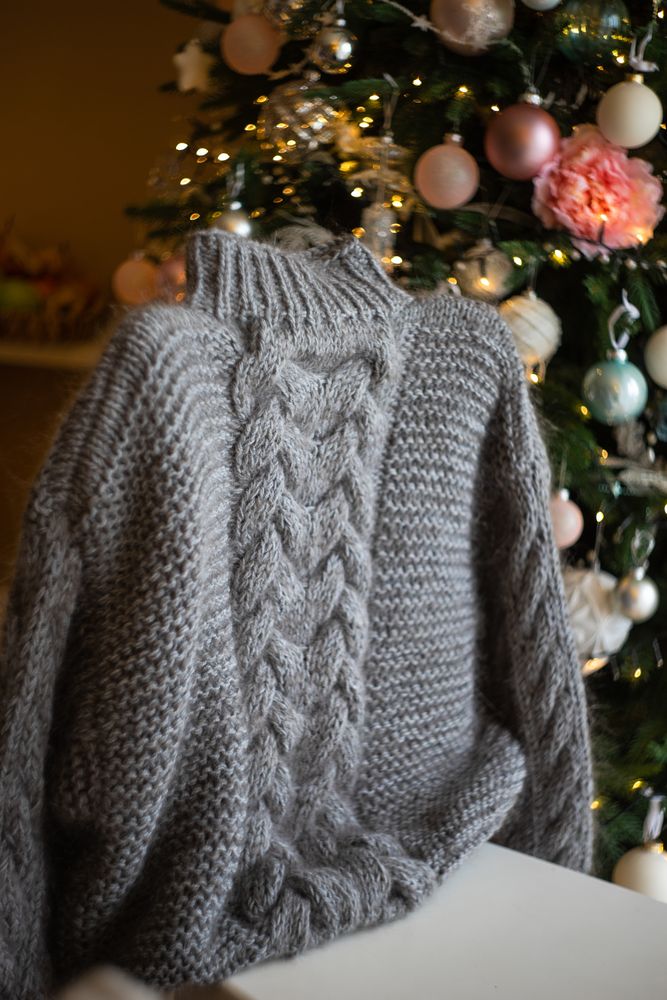 Vintage knitting sweeter on chair in front of Christmas tree