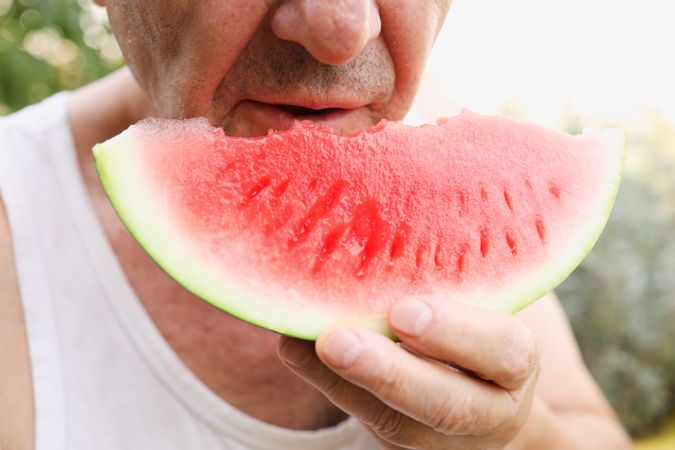 Older Man Enjoying a Watermelon.