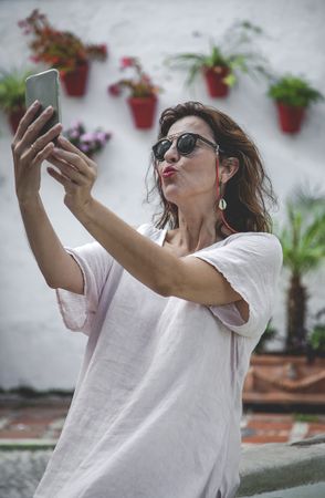 Woman taking a selfie on phone in town
