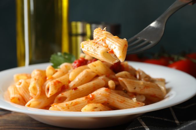 Composition with plate of tasty pasta on wooden background, close up
