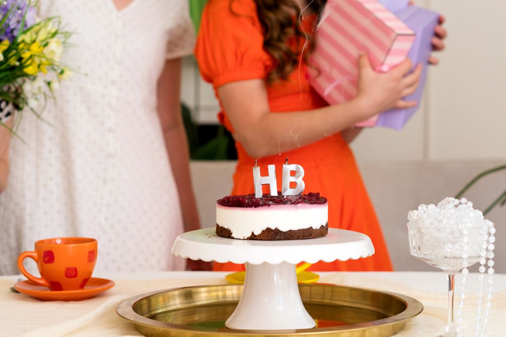 Young girl opening gift at birthday party
