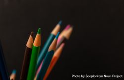 Multi colored pencils on dark background 48nAj0