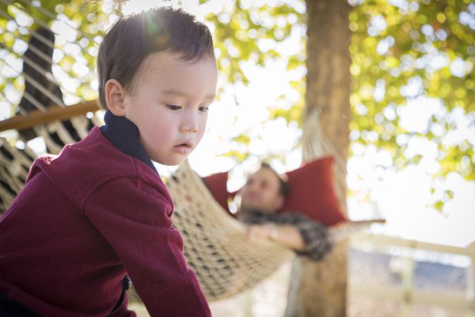 Boy Having Fun While Parent Watches From Behind