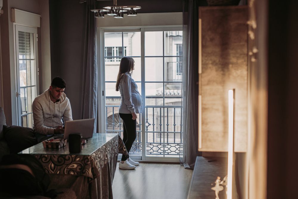 Pregnant wife and husband spending time at home