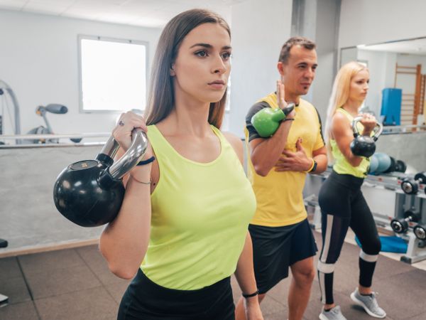 Athletes with kettlebells at the gym