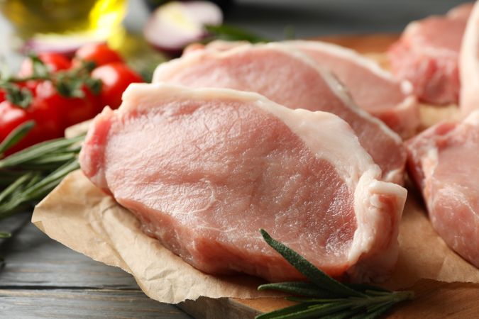 Composition with raw meat for steak and ingredients on wooden background