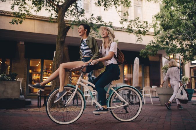 Beautiful women enjoying on bicycle in the city