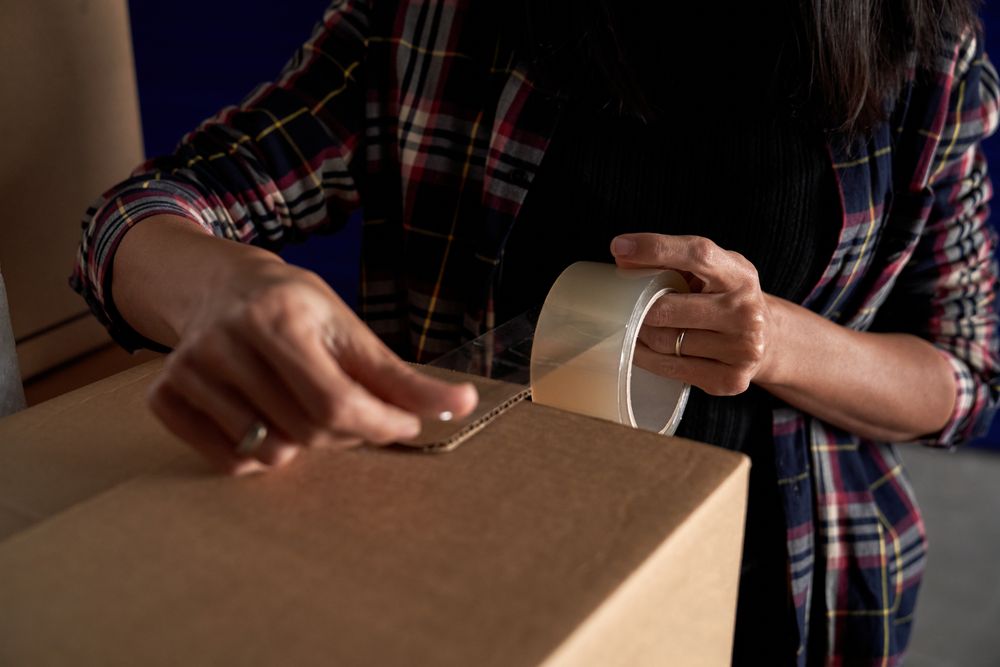 Anonymous woman packing carton box