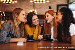 Group of friends meeting in a coffee shop 5zXjPb