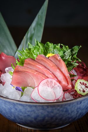 Ceramic plate with raw fish and vegetables
