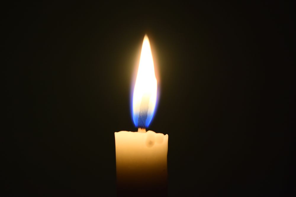 Candle glowing in the dark
