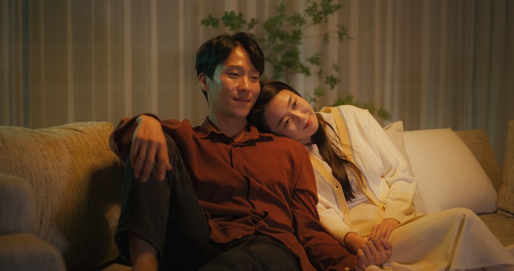 Portrait of a South Korean Couple Watching Romantic Comedy Movie on TV.