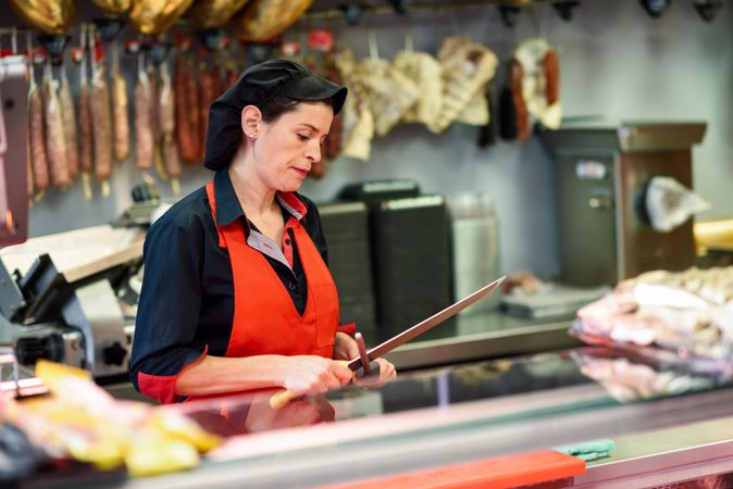 Female butcher sharpening knife