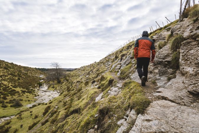 Man walking on hill near valley