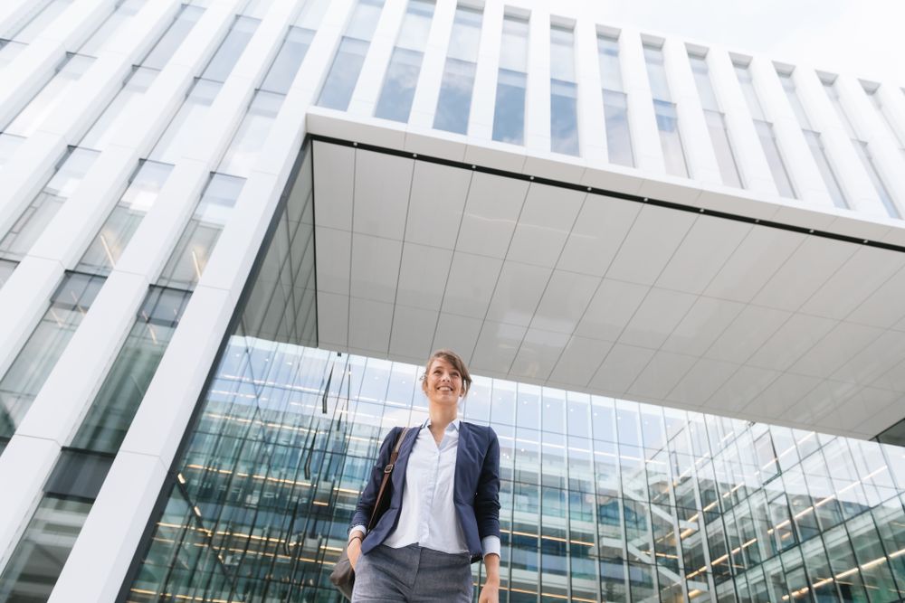 Happy female manager walking from work