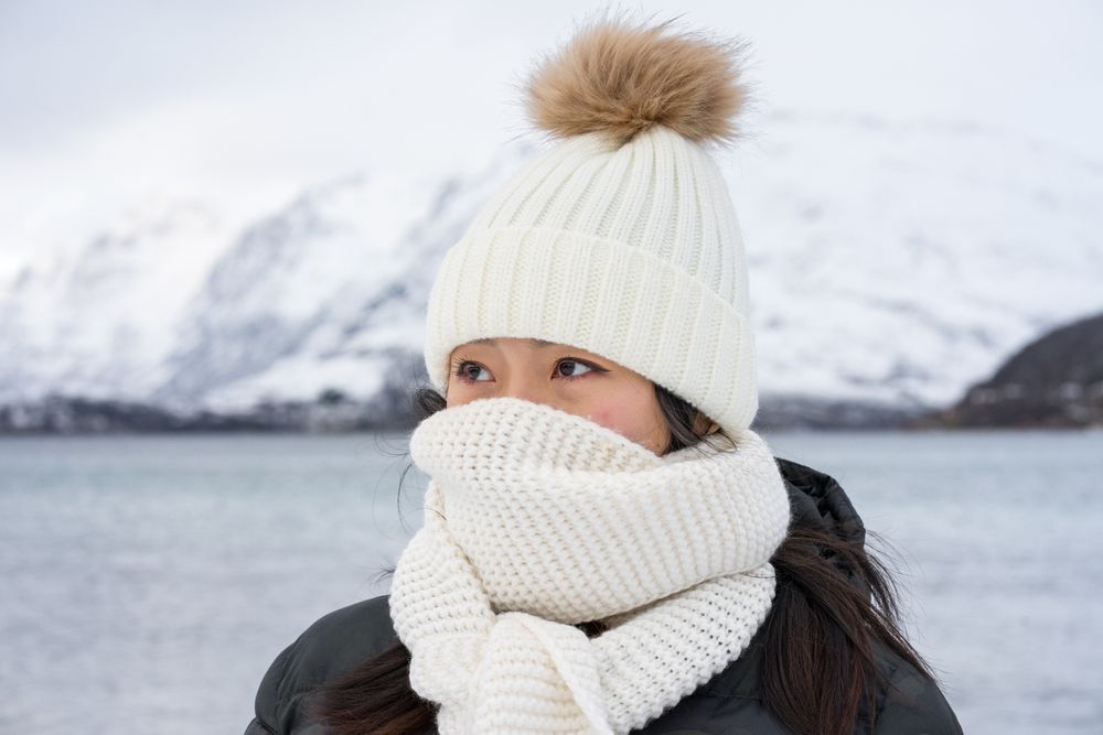 Joyful young woman in warm clothes